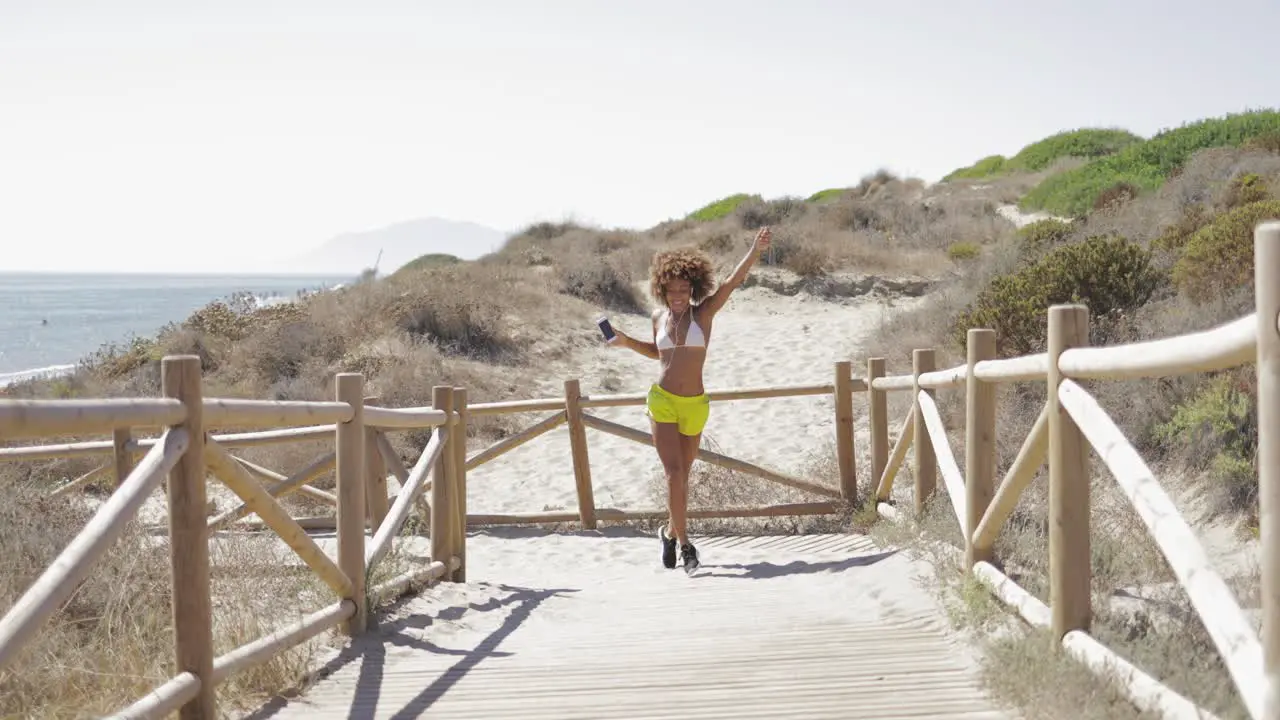 Beautiful girl dancing on coast