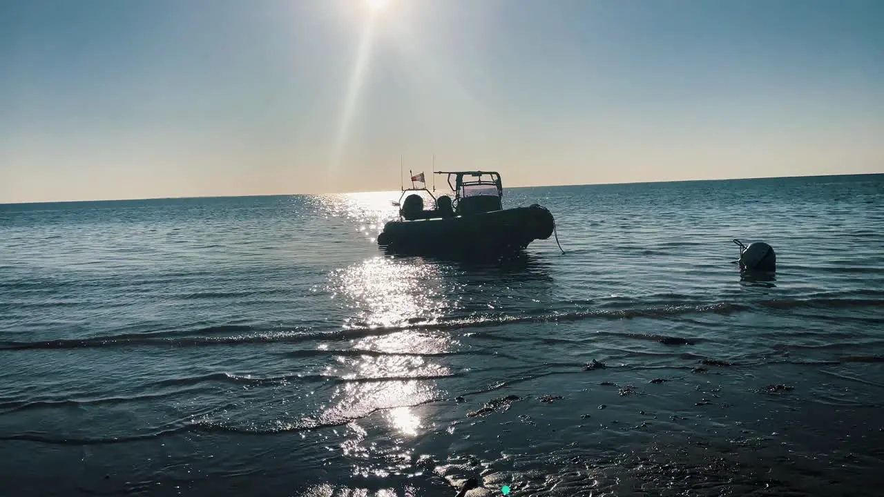 Shot of a Boat in the pleasant ocean in France reflection of the sun shining on the water waves