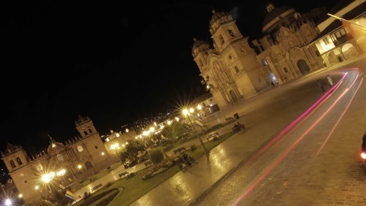 Plaza de armas at night in Cusco cars passing by