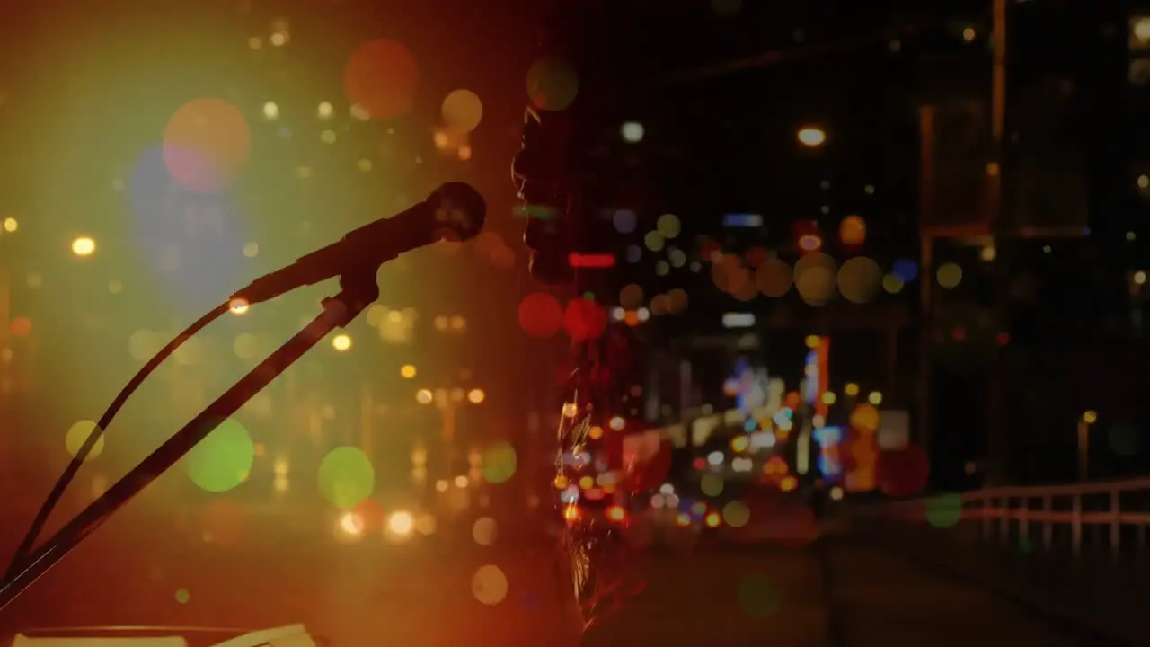 Caucasian female singer singing and playing keyboard during concert over city at night