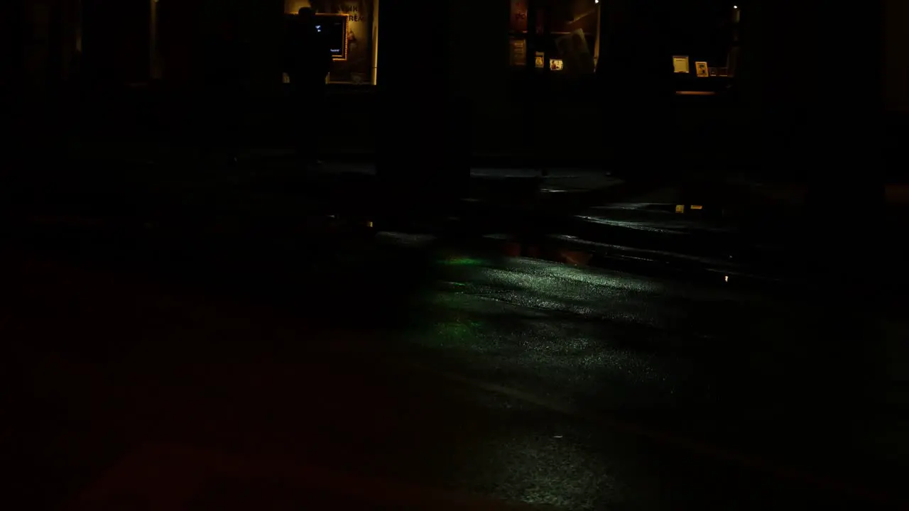 Reflection on wet street from traffic light going from green to yellow to red light