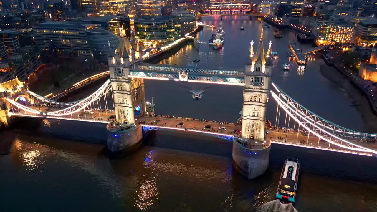 Dolly in tilt down drone shot of the Tower Bridge in London England