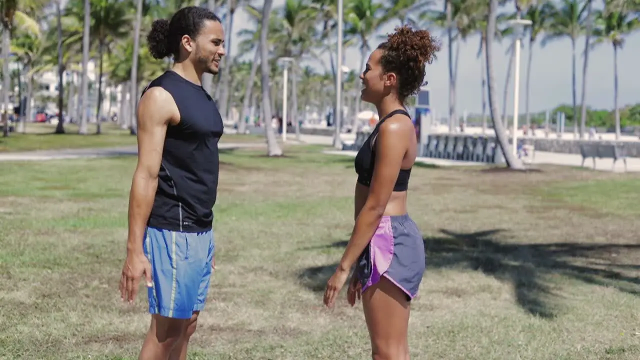 Athletic couple warming up in park