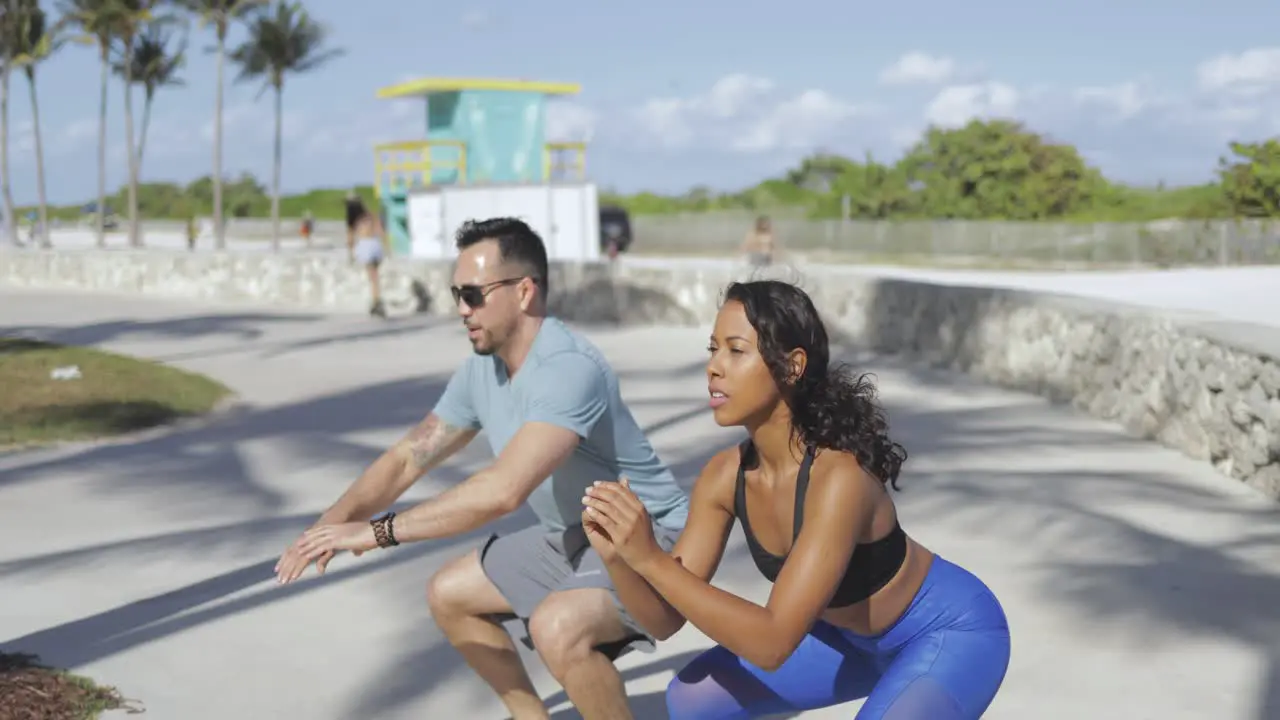 Couple working out on seafront