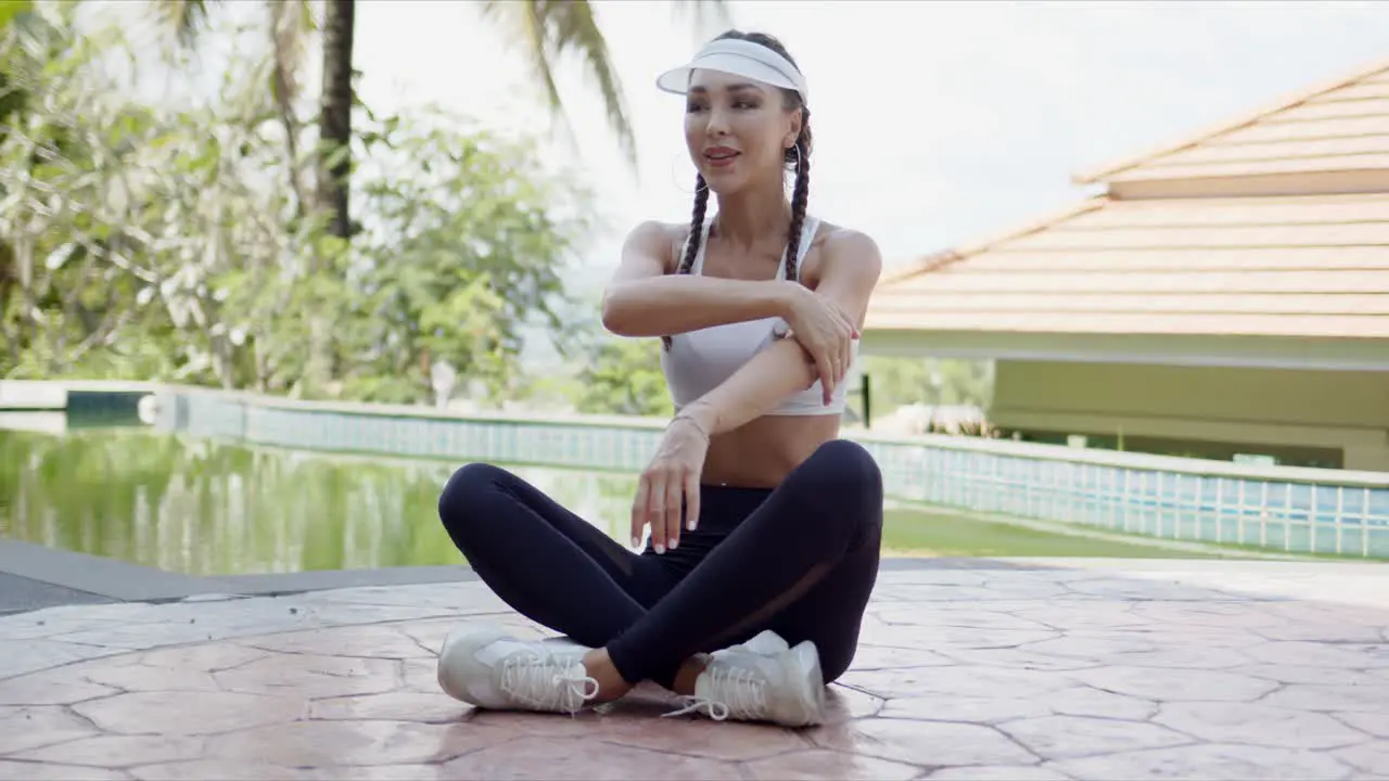 Cheerful female stretching arms during swimming pool