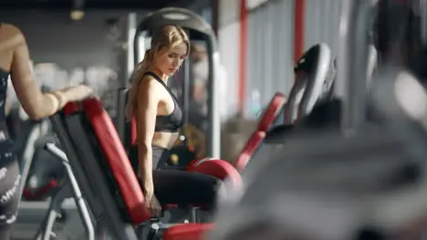 Fitness woman doing exercise on sport simulator in sport club