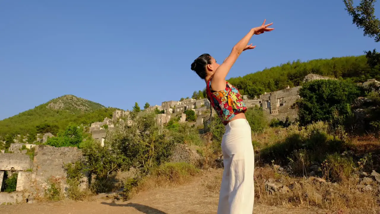 woman does yoga and stretches in a natural space