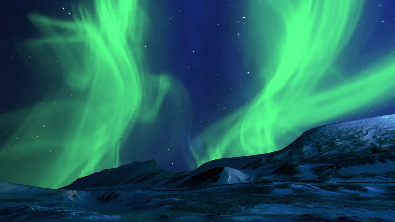 Winter landscape of snowy mountains with starry night sky and green polar lights