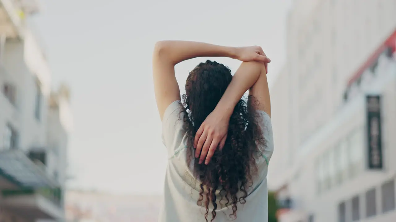 Fitness woman back or stretching arms in city