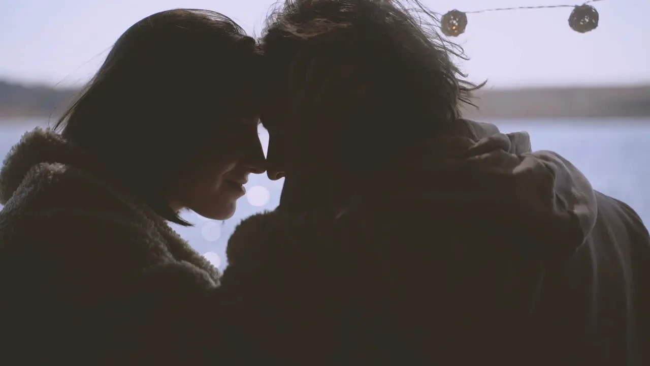 A Young Couple In Love Put Their Heads Together In The Back Of A Caravan By A Lake