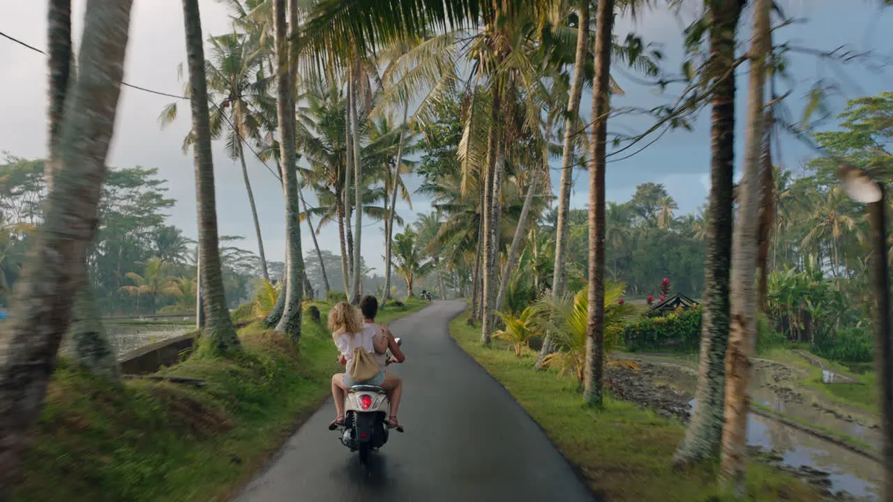 travel couple riding motorcycle on tropical island exploring beautiful travel destination on motorbike ride in morning mist