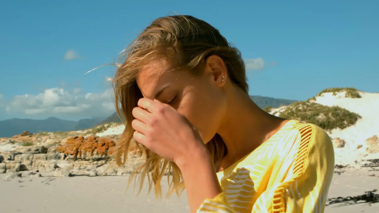 Side view of young Caucasian woman relaxing on the beach 4k