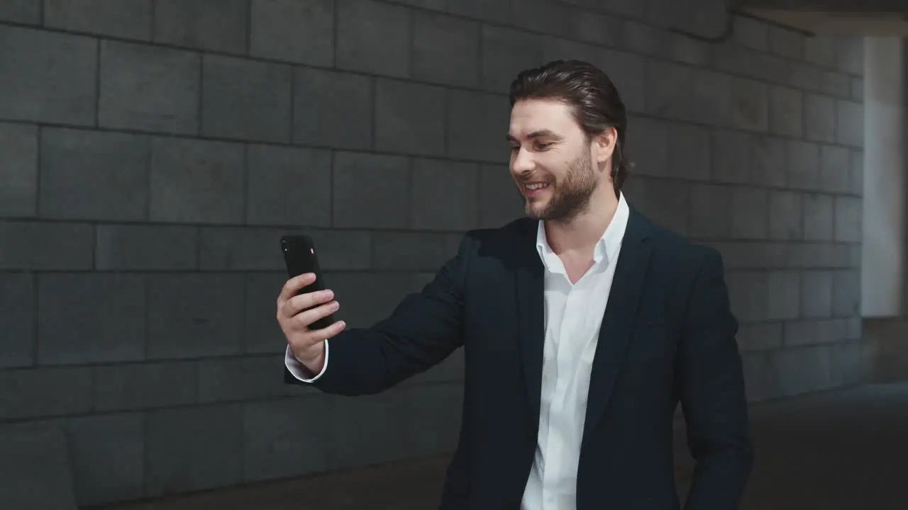 business man waving hand at camera on street Entrepreneur talking on video chat