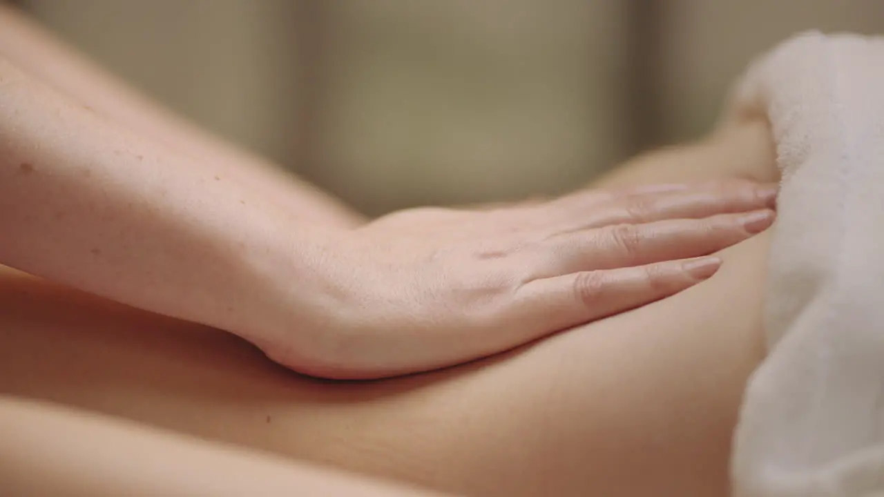 relax and pleasure in massage parlor in spa salon closeup of masseuse hands on body of patient