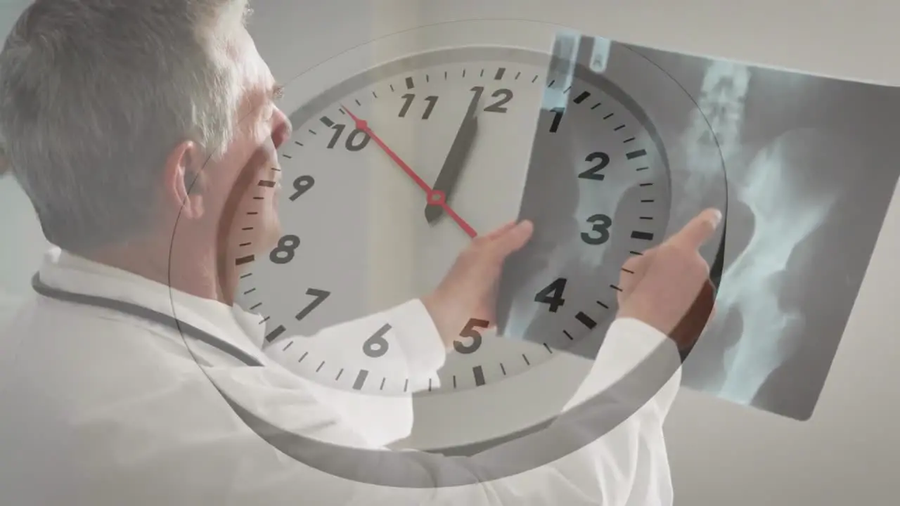 Animation of ticking clock against caucasian male senior doctor examining x-ray report at hospital