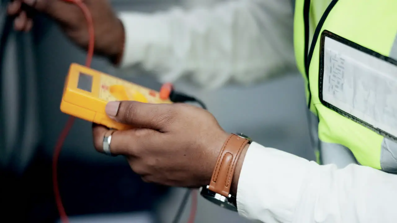 Technician hands and multimeter testing power