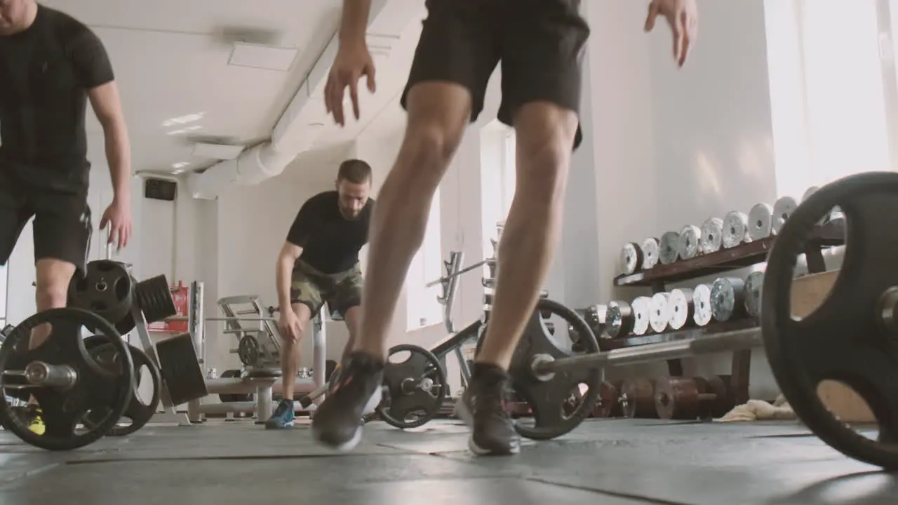 A Group Of Young Man Doing Burpees In The Gym During A Class