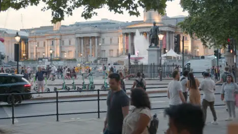 Busker With Guitar Playing To Tourists In Trafalgar Square In London England UK 1