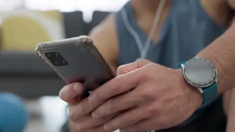 Fitness man with phone listening to audio