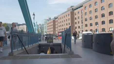 Summer Tourists Walking Down Steps At Tower Bridge London England UK With Traffic