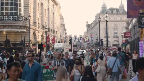 Crowd Of Summer Tourists Walking From Leicester Square Towards Piccadilly Circus In London England UK 1