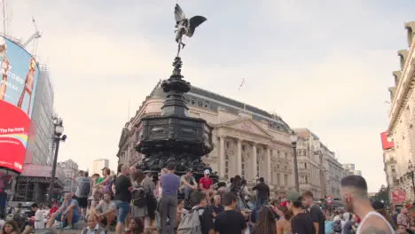 Crowd Of Summer Tourists Around Statue Of Eros In Piccadilly Circus With Digital Advertising Displays London England UK