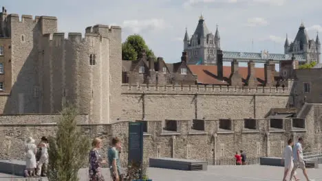 Exterior Of The Tower Of London England UK With Tourists And Tower Bridge Behind