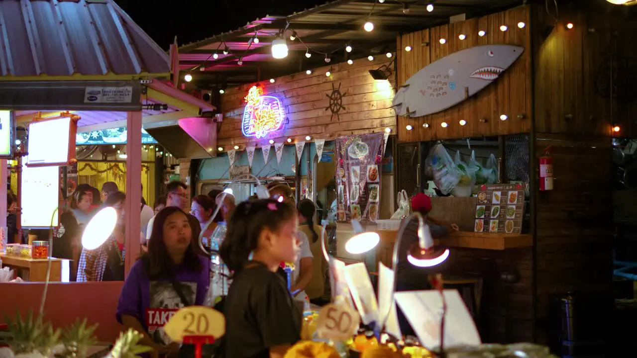 People walking in night market street in Bangkok slowmotion