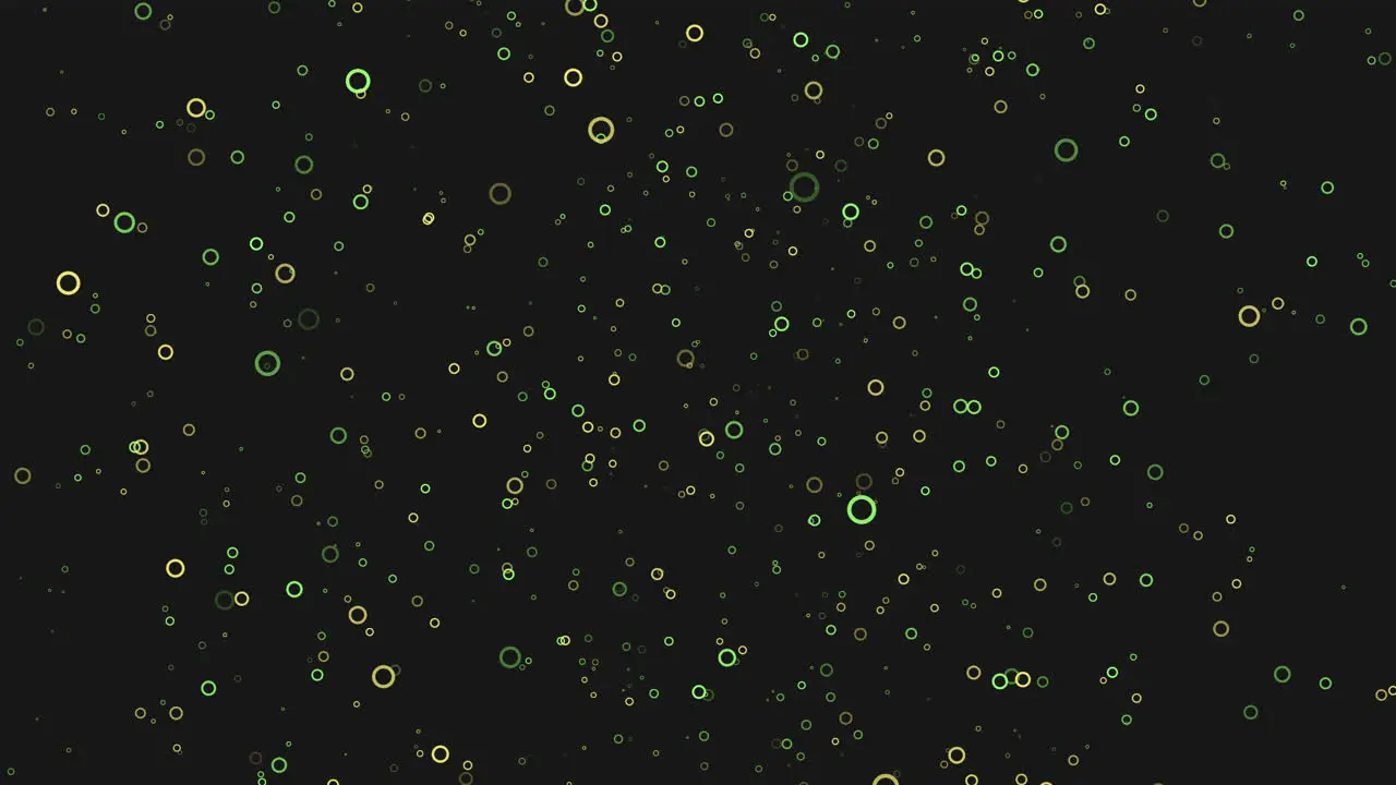 Scattered blue and green dots create dynamic pattern on black background