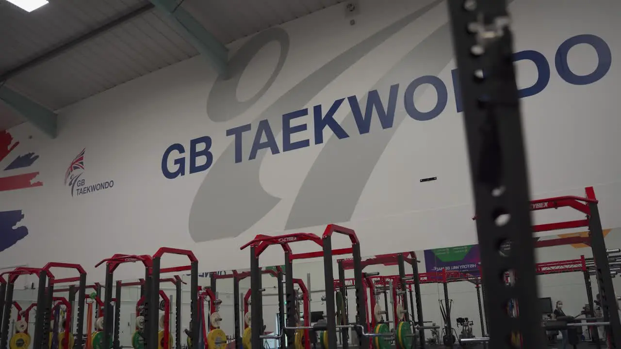 Gimbal shot of Great Britain Taekwondo sign in gym