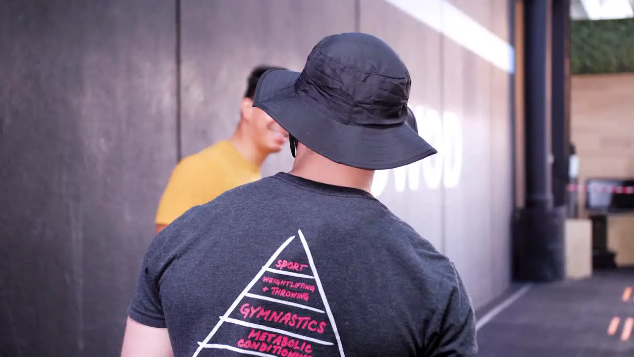 Smiling muscular man with a fishers hat attempting an open gym event