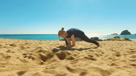 Attractive woman doing yoga exercise outdoors at sunny day