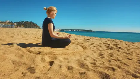 Young woman alone meditating in lotus pose Sporty girl practicing yoga