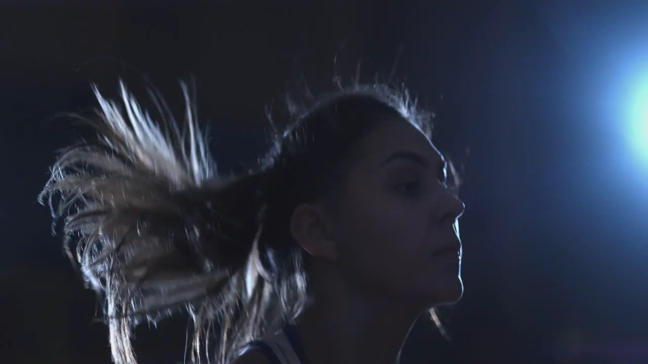 Close-up of the face of a Beautiful female boxer jumping on a rope during an active Boxing workout