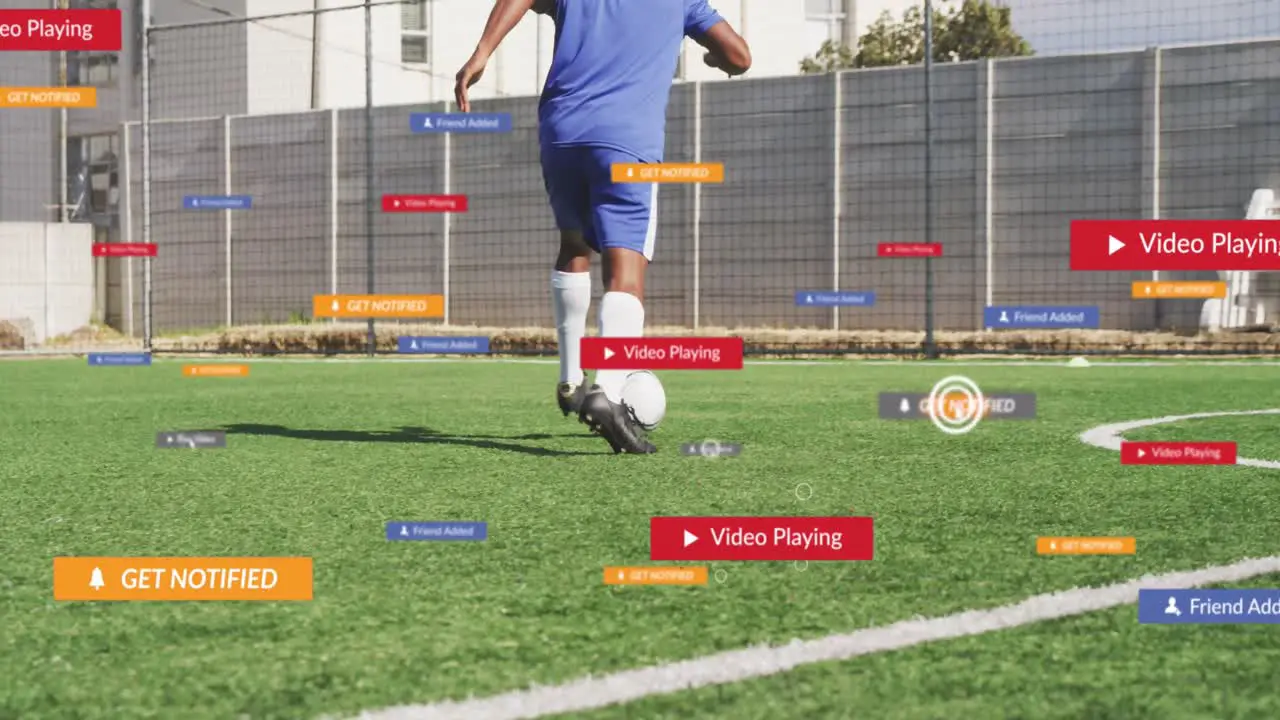 Animation of social media icons over rear view of male soccer player dribbling on sports field