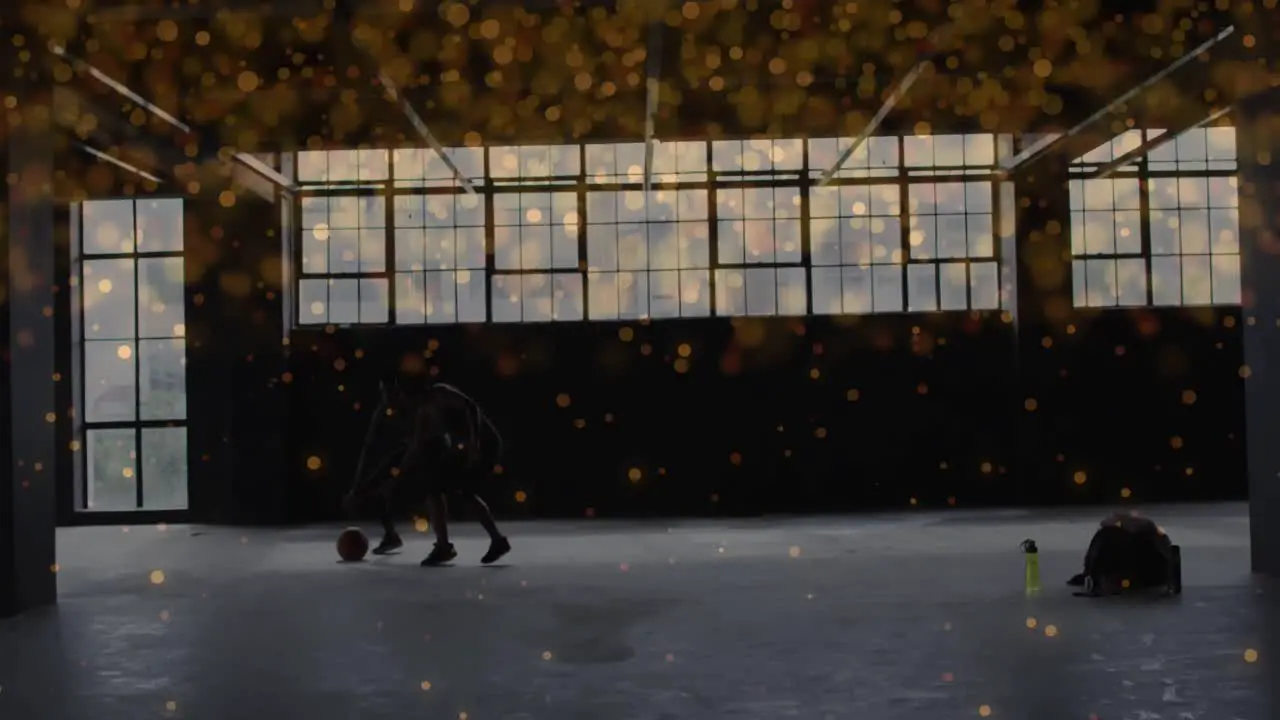 Orange spots moving against african american man and woman practicing basketball