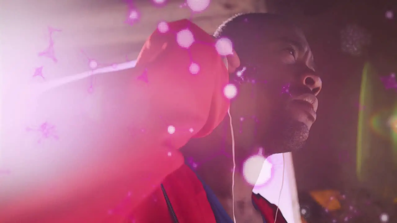 Glowing molecular structures floating against african american male boxer wearing earphones