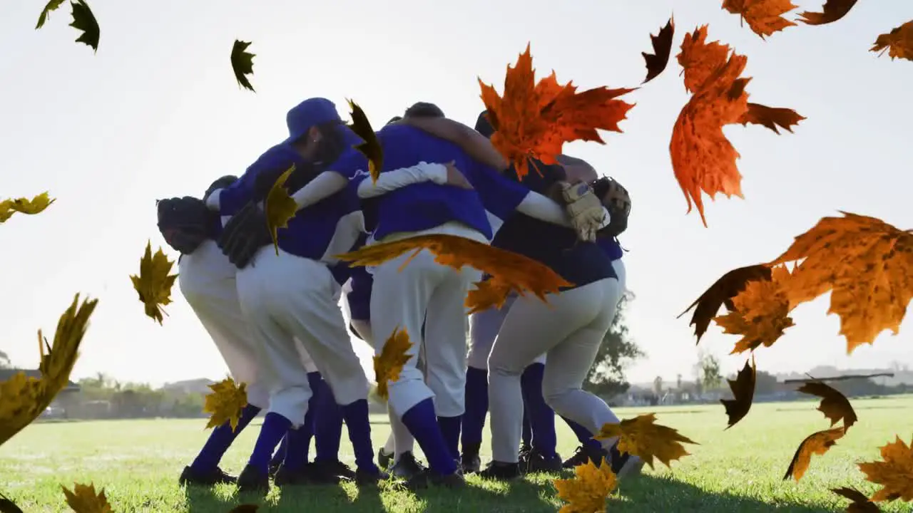 Multiple leaves icon floating against team of male baseball players forming a huddle