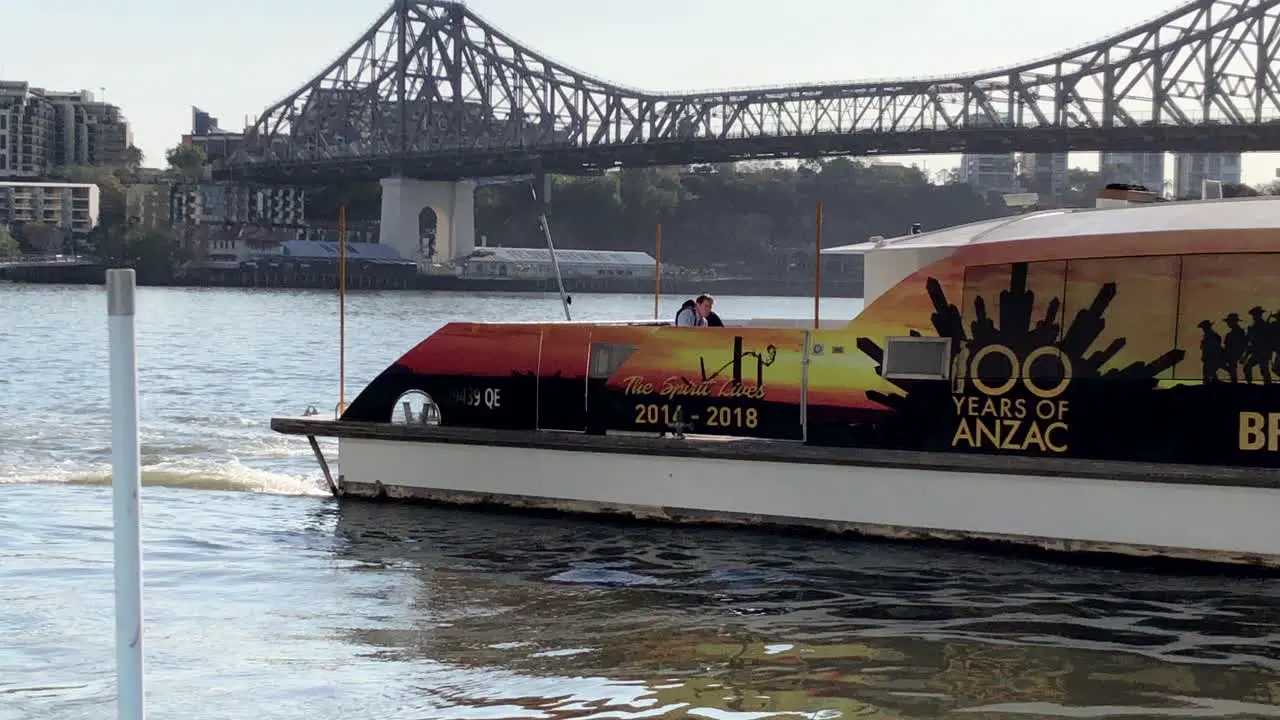 Brisbane City Cat sails in front of Story Bridge