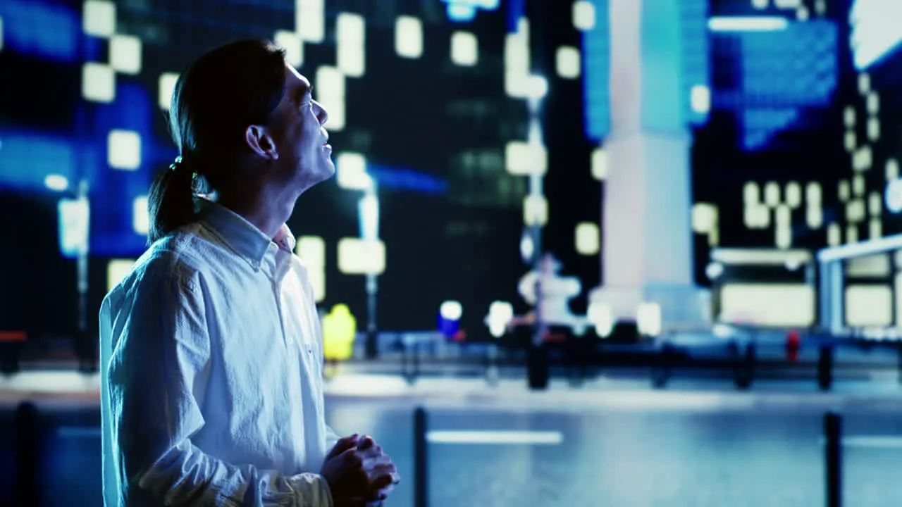 Man laughing walking in city at night