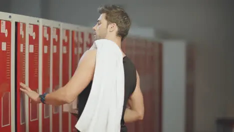 andsome guy taking towel and bottle for training