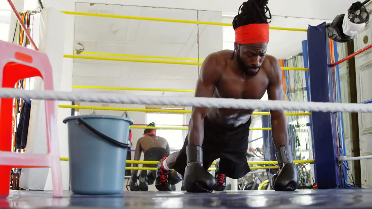 Male boxer exercising in boxing ring 4k