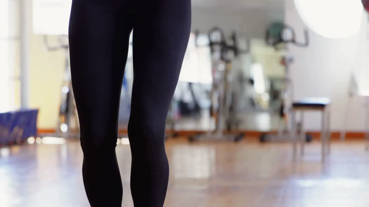 Female boxer exercising with skipping rope 4k