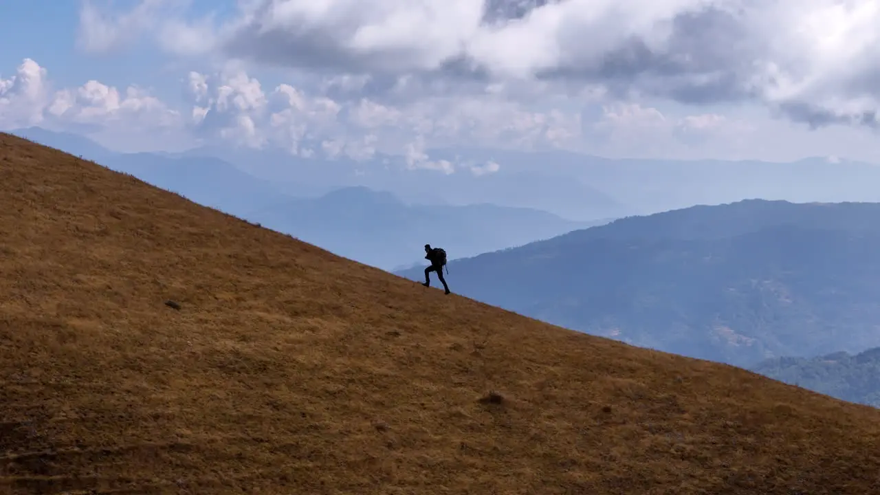 A male tourist running at Hills of Peaky Peak Nepal landscape capture drone shot 4K