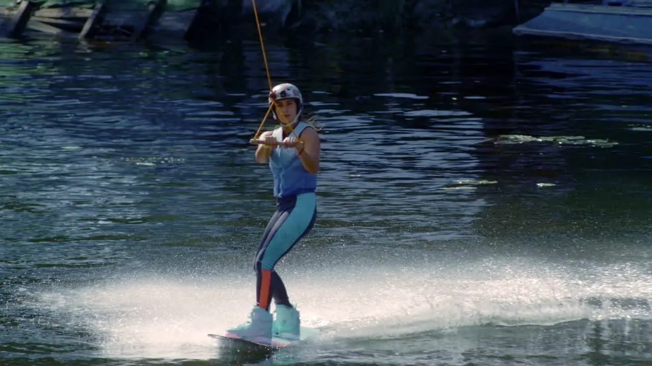 Slim girl waterskiing during her vacations