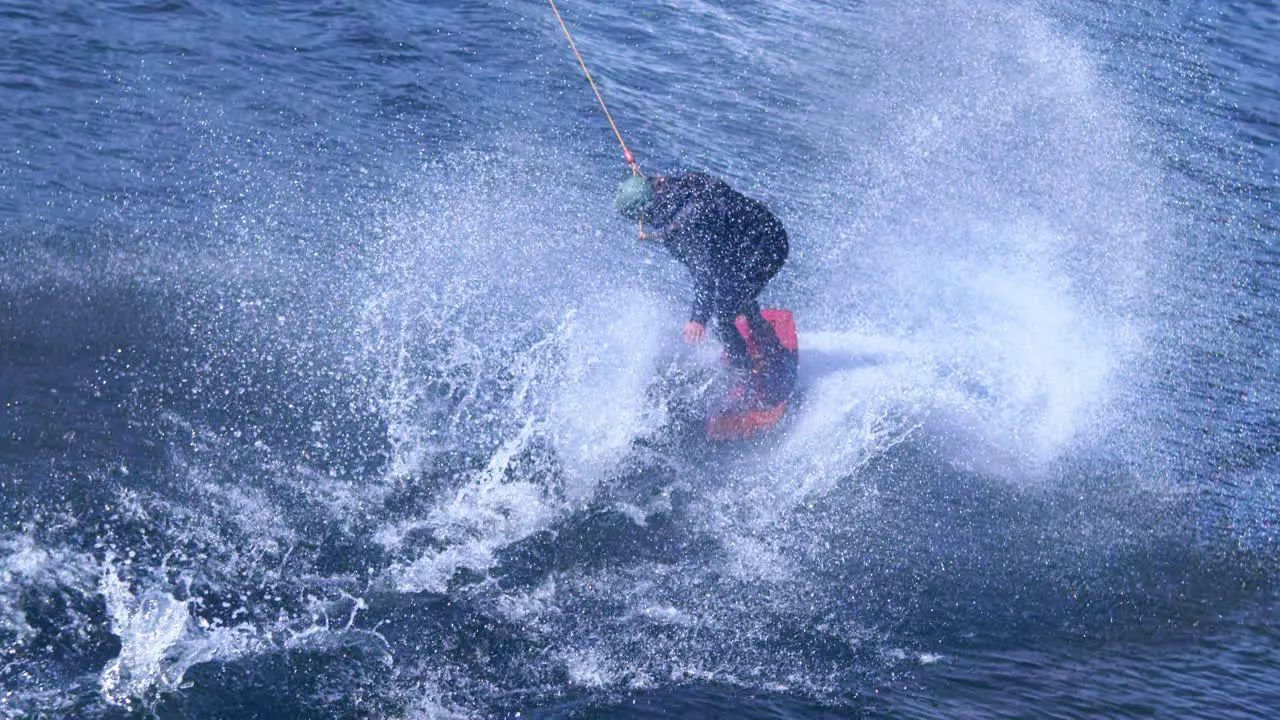 Extreme man studying riding wakeboarding stunt on water