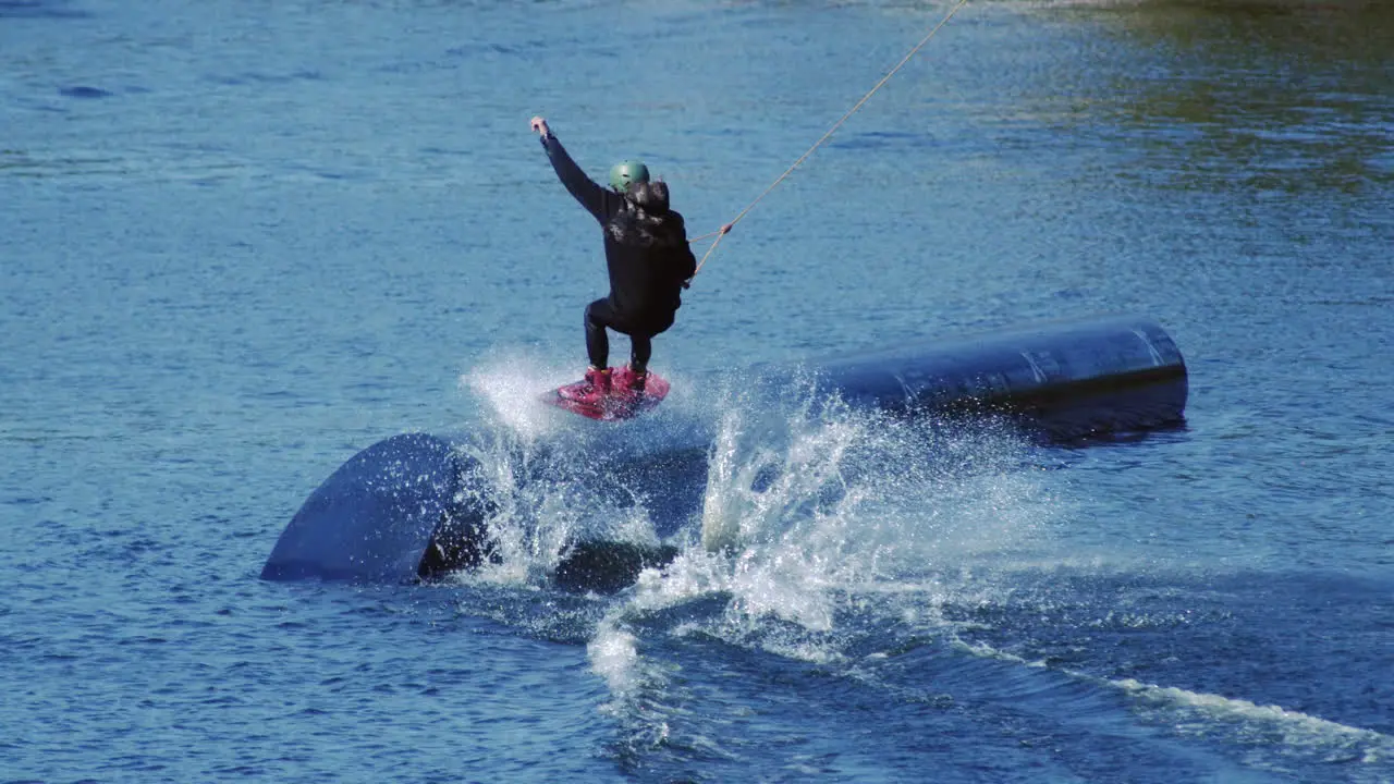 Rider wakeboarding in cable wake park