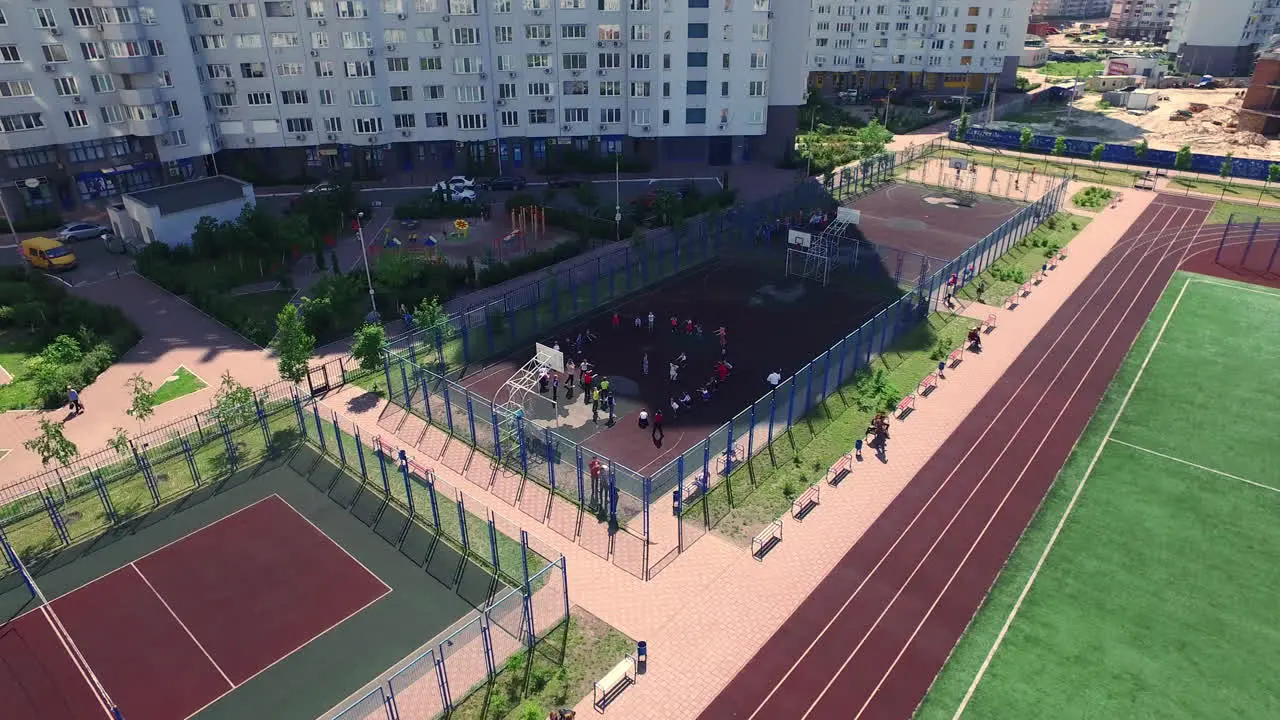 Aerial view childrens training sport class on basketball court in school yard