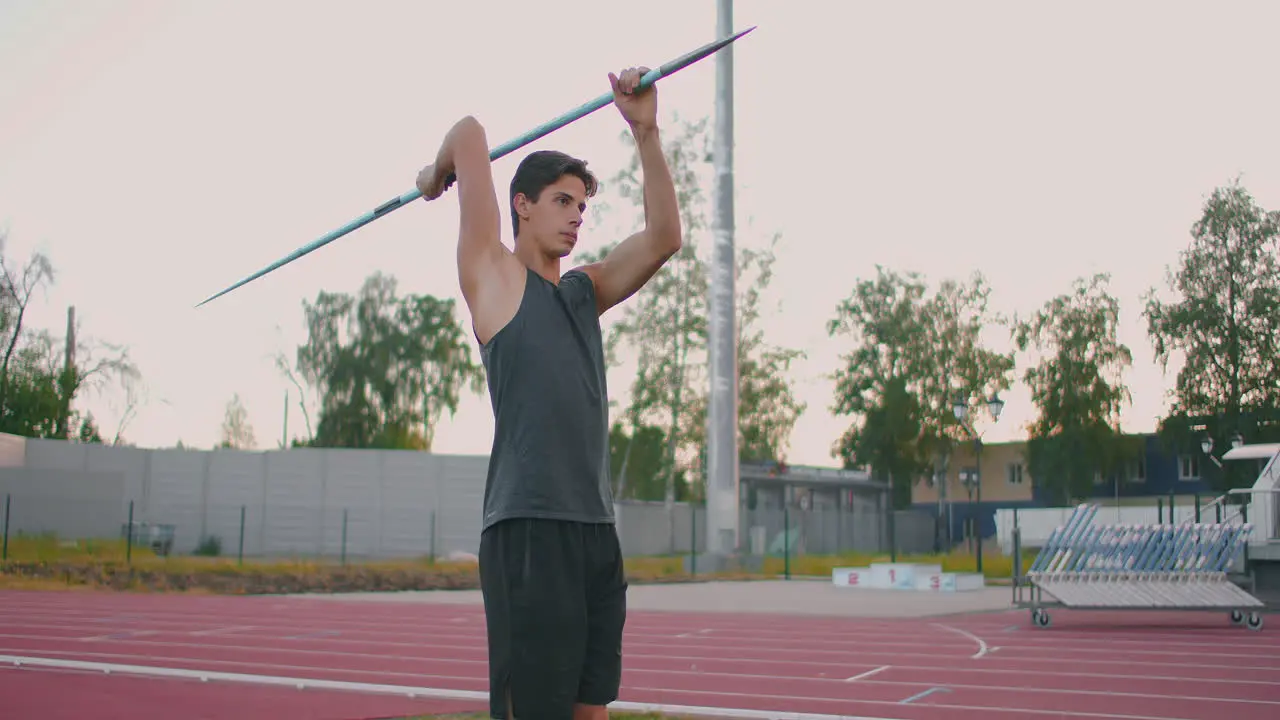 Run-up and javelin throw at the stadium Slo-Mo Shot of Young Man Throwing Javelin One caucasian man javelin thrower on stadium