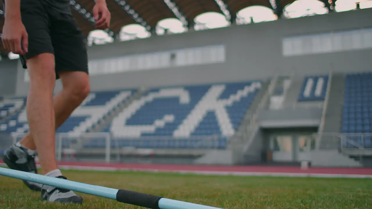 Close-up Hand a Male athlete at the stadium takes a javelin for throwing and prepares to make a throw Goes takes the spear Training of a javelin thrower